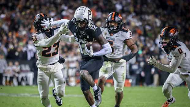 Colorado Buffaloes cornerback Travis Hunter (12) breaks past Oregon State Beavers defensive back Jermod McCoy (23) at Folsom Field